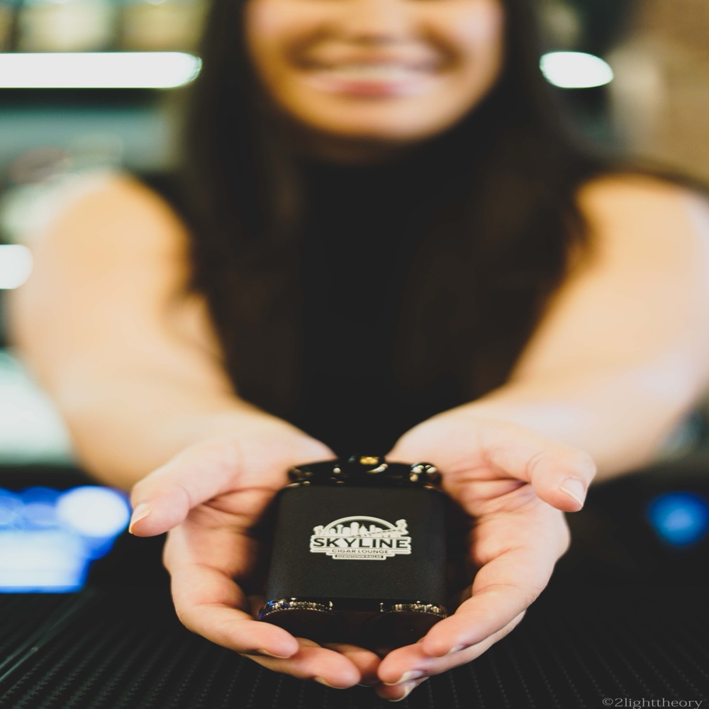 A Skyline ashtray held in two hands