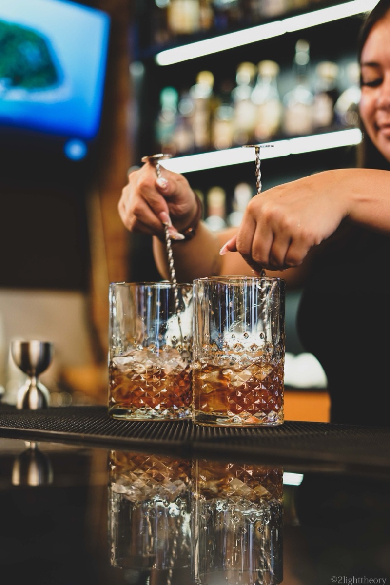 Two glasses being stirred side by side