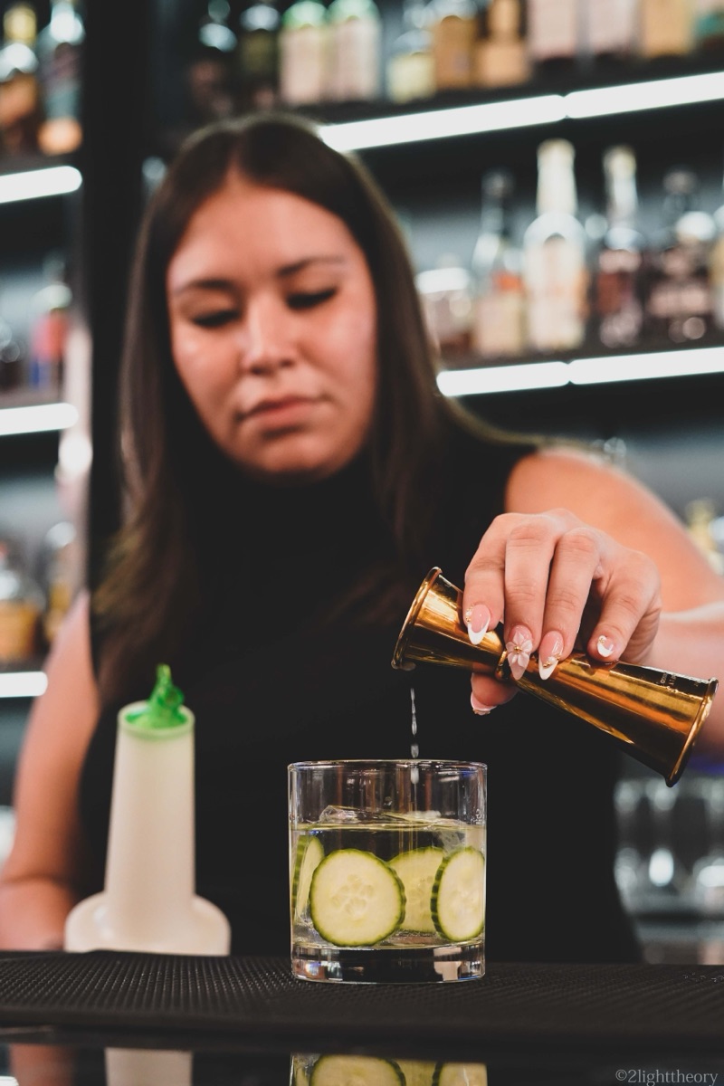 A drink being poured at the bar